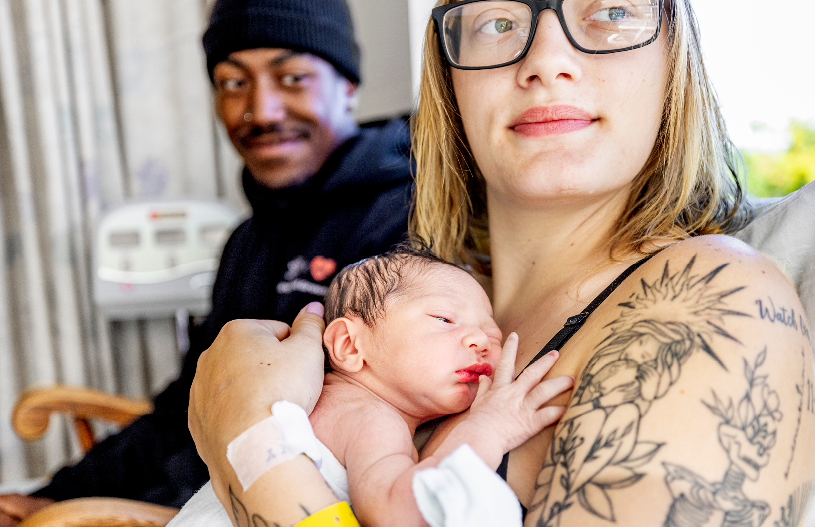 Mother and father holding their newborn